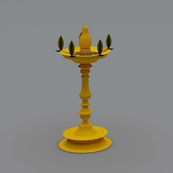 Yellow traditional brass oil lamp with green leaves on grey background