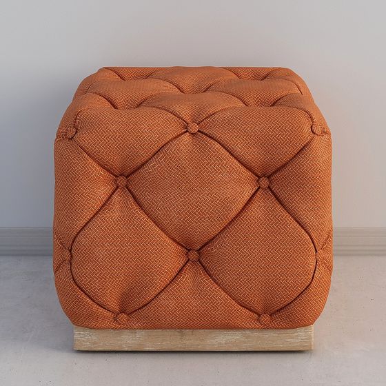 Orange fabric tufted ottoman with wooden base on grey background