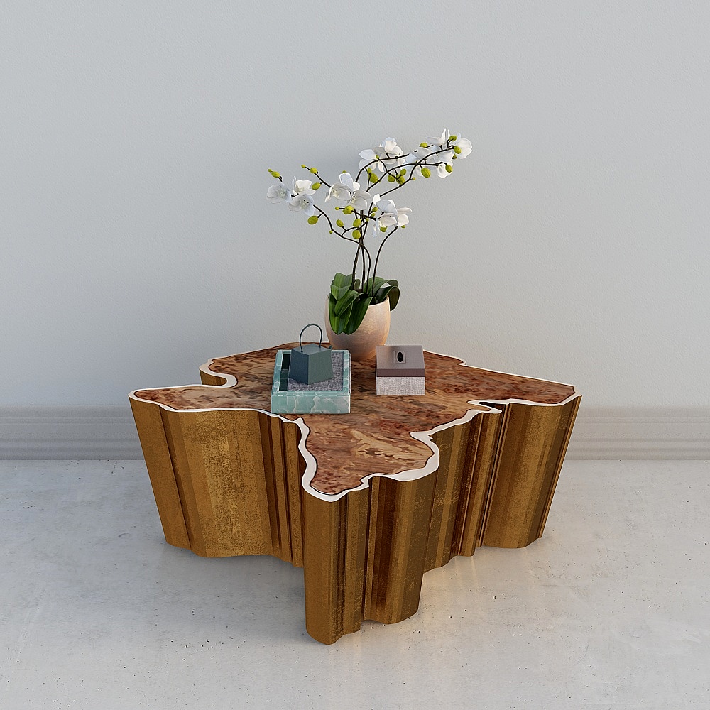Modern gold coffee table with burl wood top and decorative items on white background