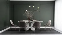 Elegant dining room with dark green wall panels marble table grey chairs and ceiling light