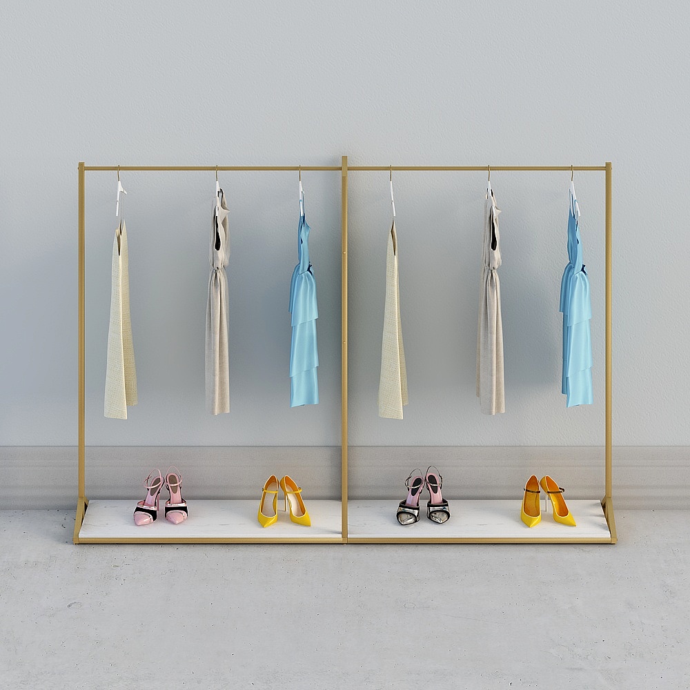 Gold metal clothing rack with hanging dresses and colorful high heels on grey background