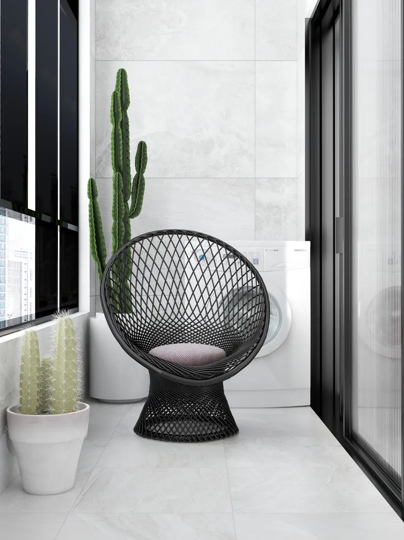 Modern balcony with black wire chair, green cactus plants, white washing machine, and grey floor