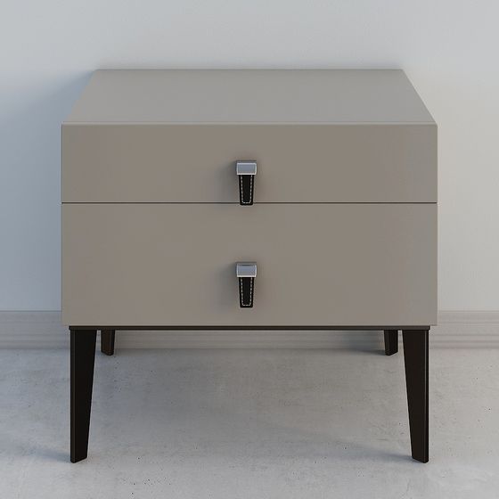 Modern beige two drawer nightstand with black leather handles and dark wooden legs on white background