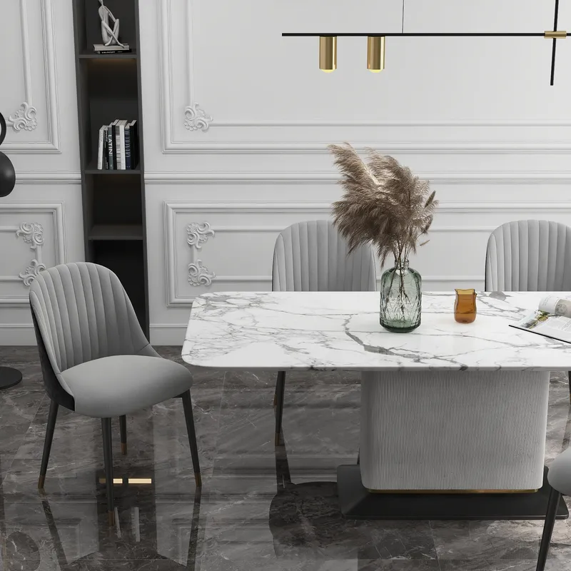 Marble dining table with grey chairs, white wall panel, bookshelf, and ceiling light in room