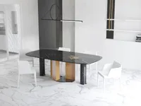 Spacious dining room showing black marble table white chairs marble floor and glass sliding door