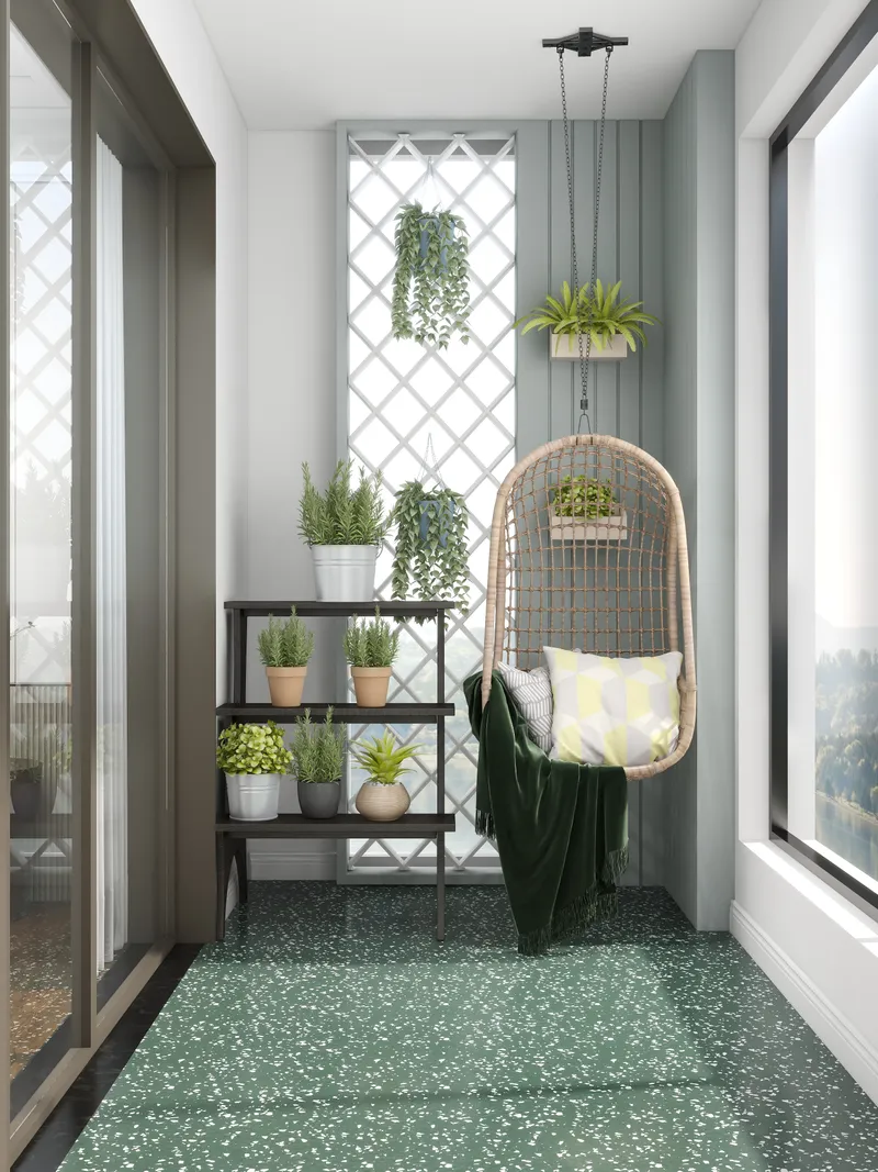 Modern balcony with a hanging chair, potted plants on a shelf, and green floor tiles