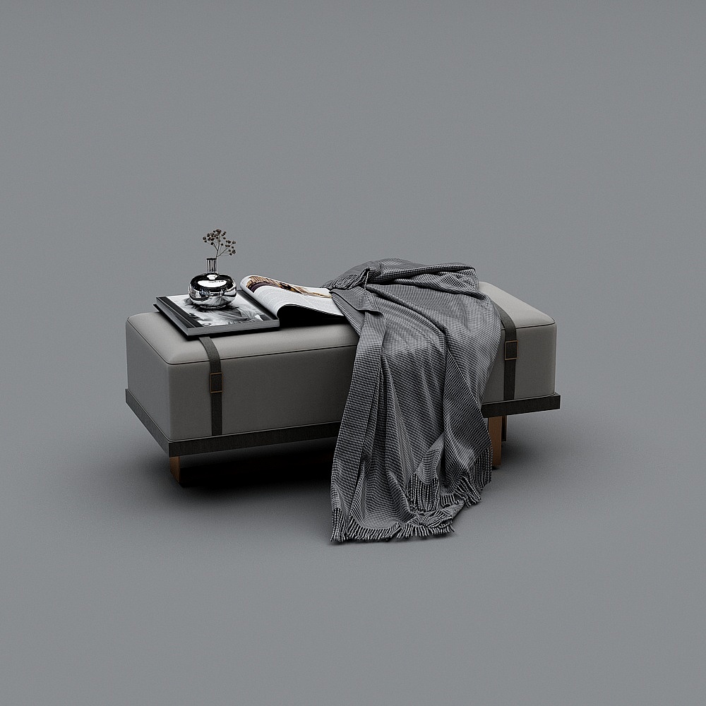 Grey leather footrest with black straps and grey blanket on grey background