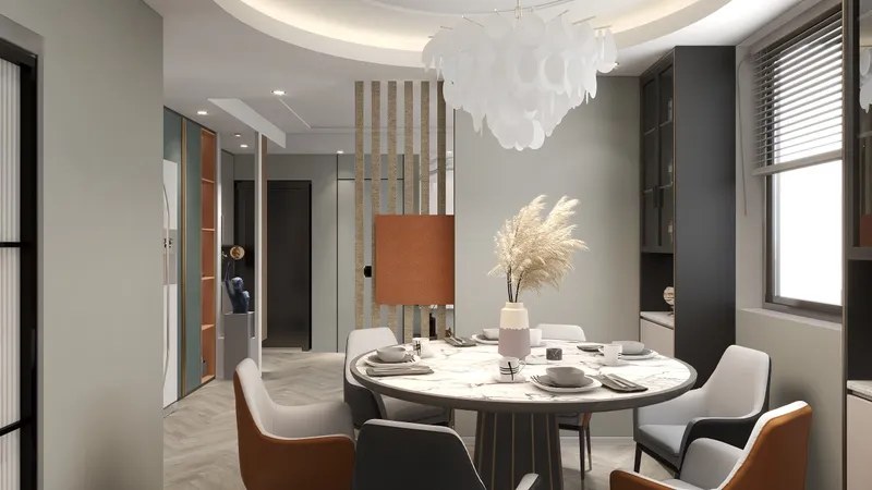 Modern dining room featuring round marble table with white and orange chairs plus ceiling light