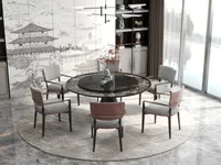Dining room featuring round table grey and pink chairs cabinet and a view through windows