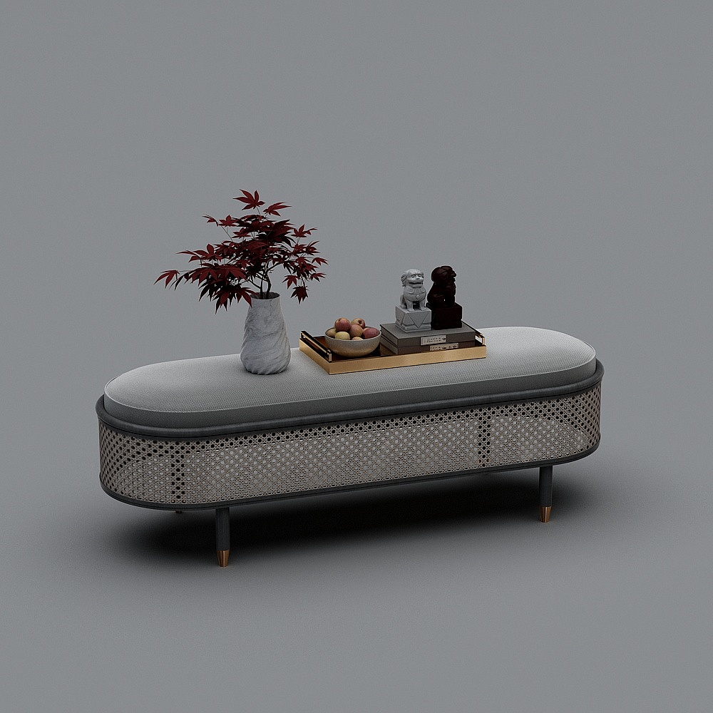 Oval grey fabric footrest with woven rattan sides and gold legs on grey background