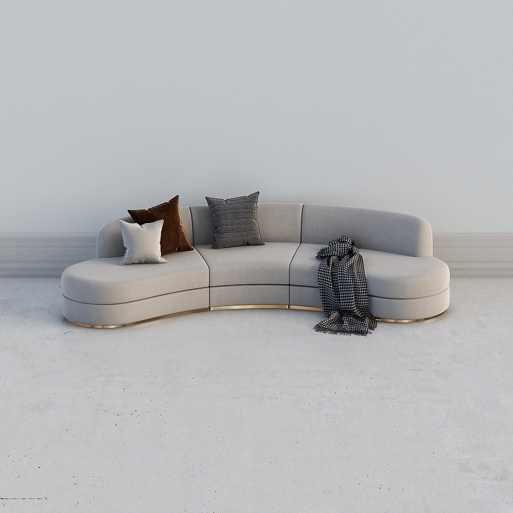 Curved beige fabric sofa with gold base and pillows on white background