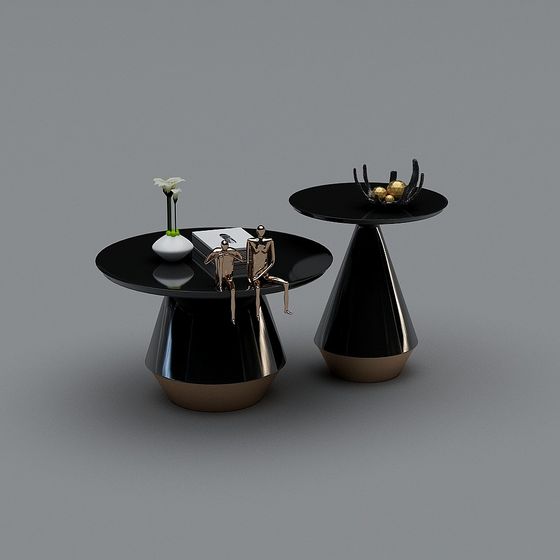 Modern black round side tables with gold bases and decorative items on grey background