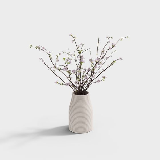 Tall white ribbed ceramic vase holding thin branches with small pink flowers on white background