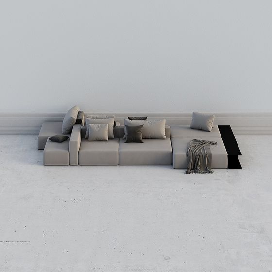 Modern light grey fabric sectional sofa with pillows and black side table on white background