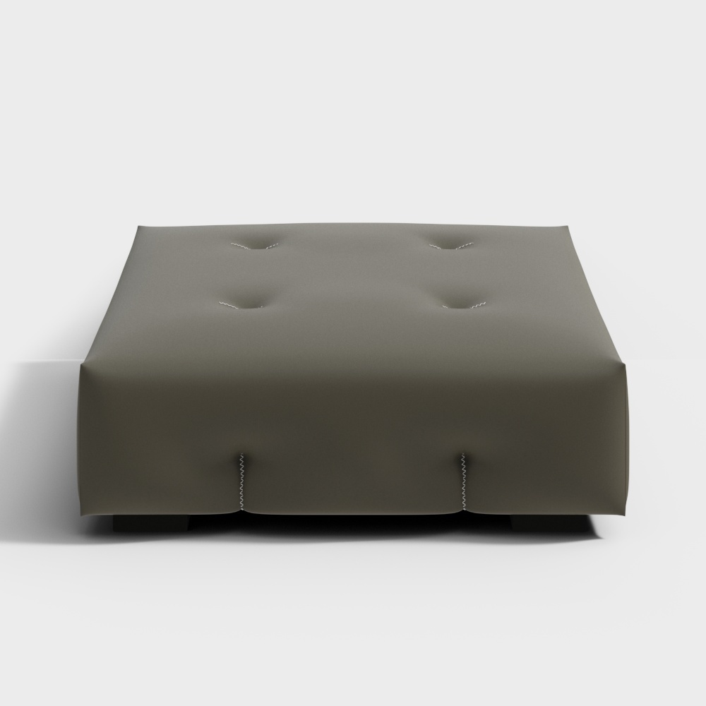 Modern dark grey fabric footrest with tufted top and visible stitching on white background