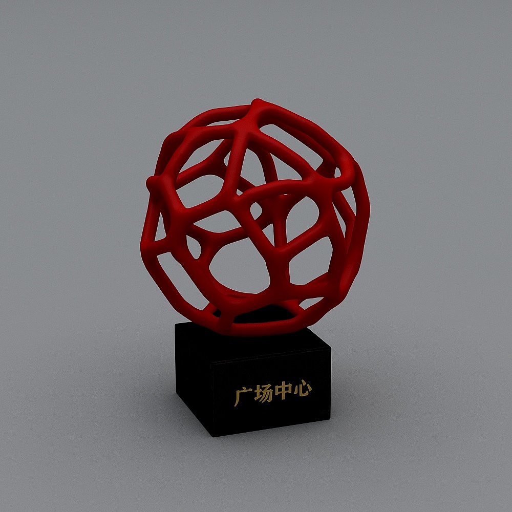 Red geometric sphere sculpture on black base with gold text on grey background