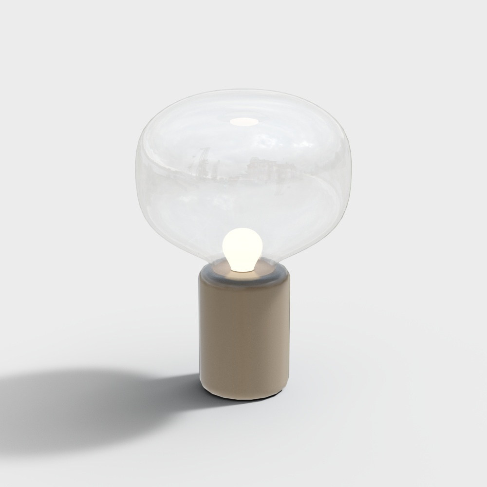 Modern table lamp with clear glass shade and beige ceramic base on white background