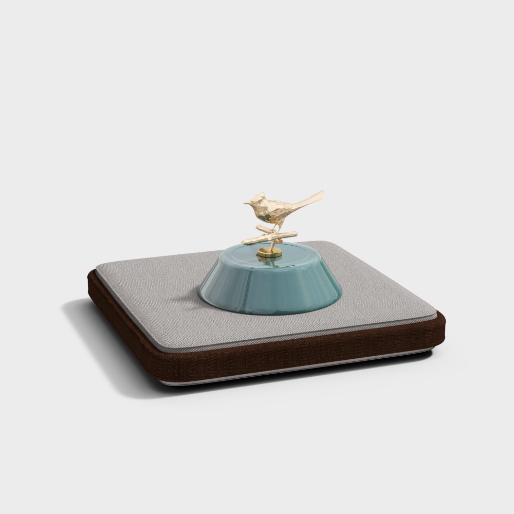 Square brown and grey cushion with blue ceramic base and gold bird on white background