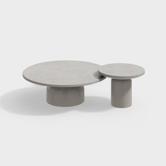 Modern round nesting coffee table set with grey stone tops and cylindrical bases on white background