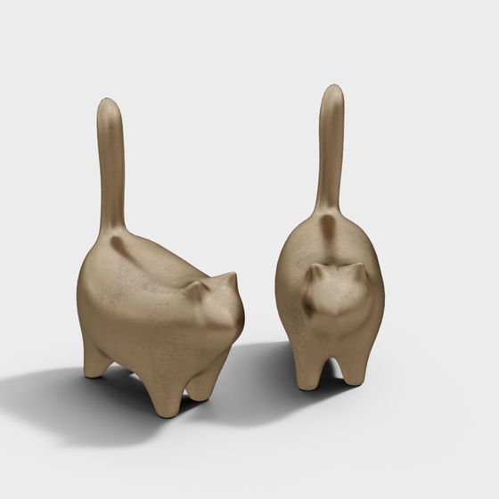Two gold metal cat figurines with raised tails and smooth texture on white background