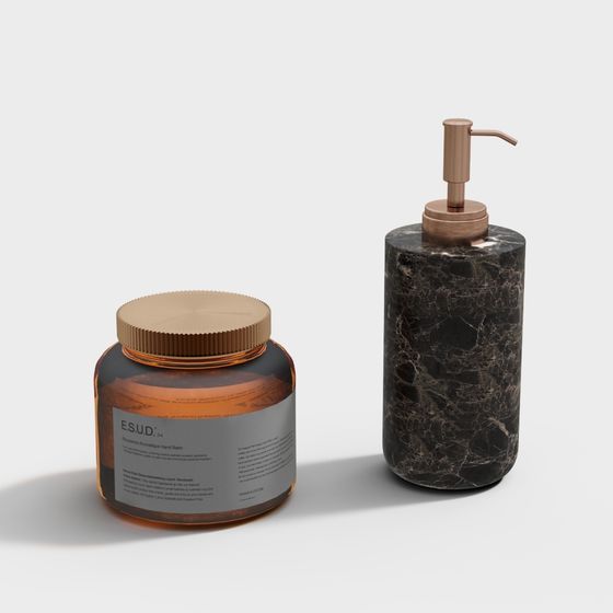 Amber glass jar and black marble soap dispenser with gold pump on white background