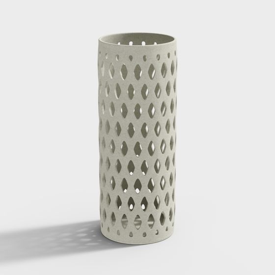Tall grey ceramic vase with diamond cutout pattern on white background