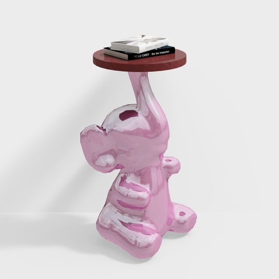 Pink glossy elephant shaped side table with round red top and two books on white background