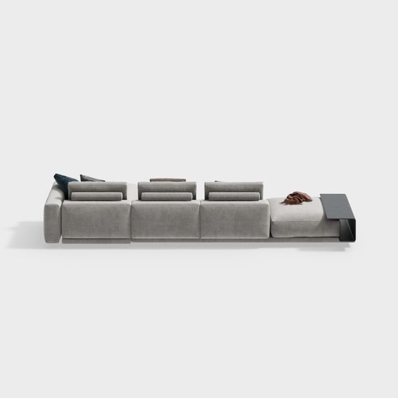 Modern large grey fabric sectional sofa with black side table and pillows on white background