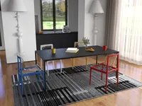 Modern dining room with black table, colorful chairs, patterned rug, and white sculptural floor lamps