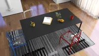 Top view of a black dining table with colorful chairs sitting on a patterned rug