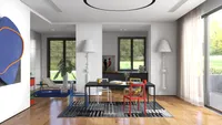 Modern dining room with black table colorful chairs patterned rug and large white light fixtures