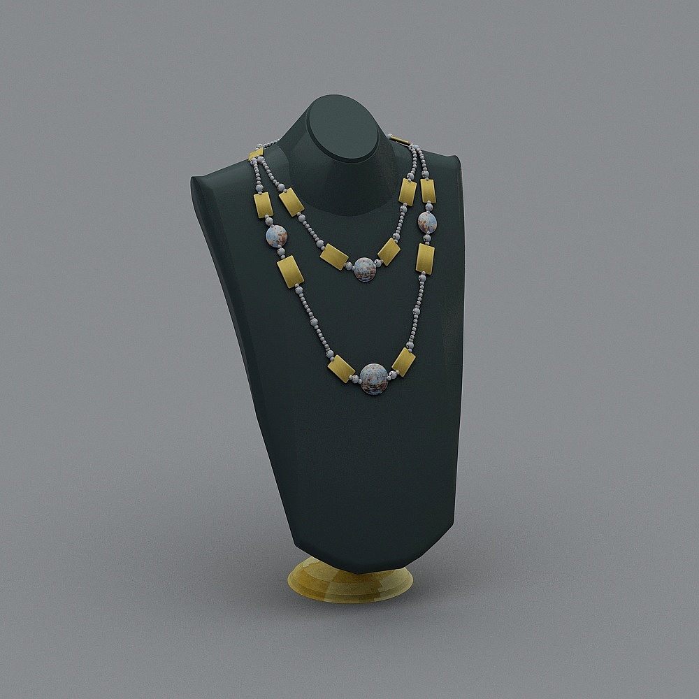 Two layer gold and stone necklace on black stand on grey background