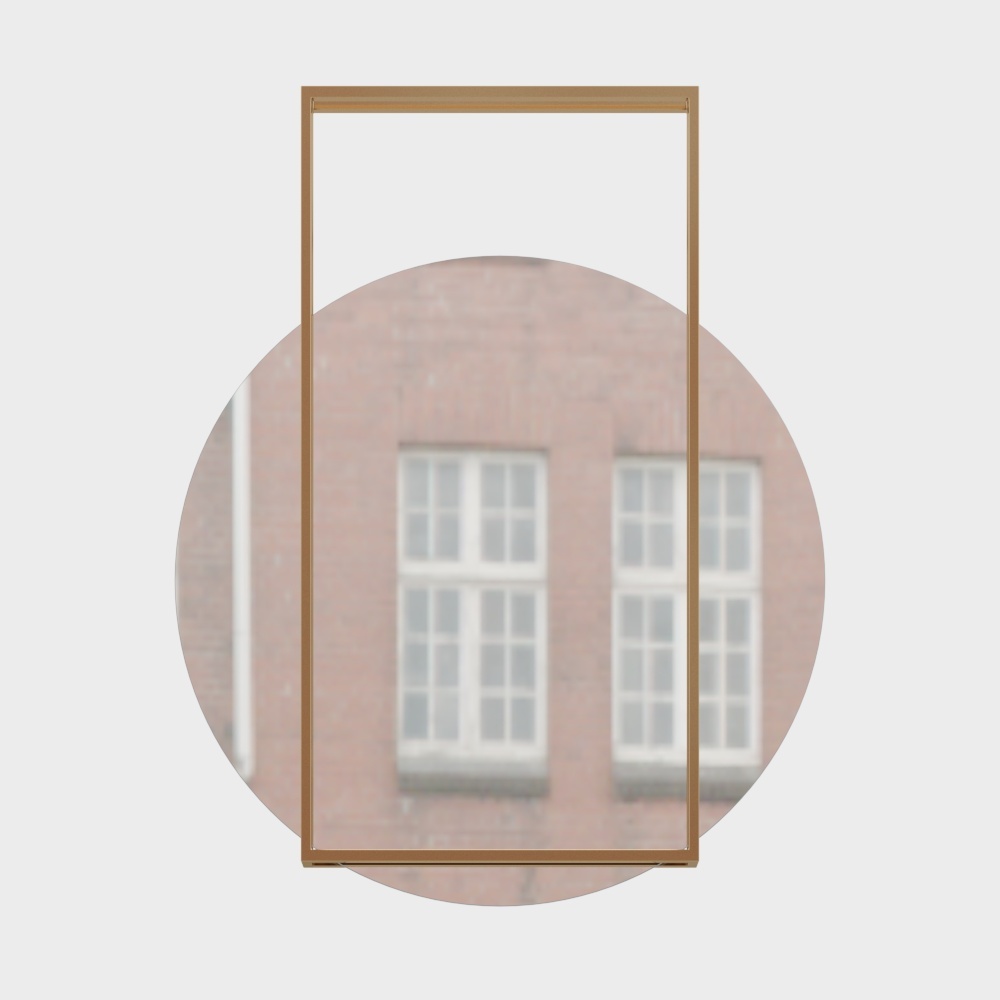 Modern rectangular mirror with thin gold metal frame reflecting brick building on white background