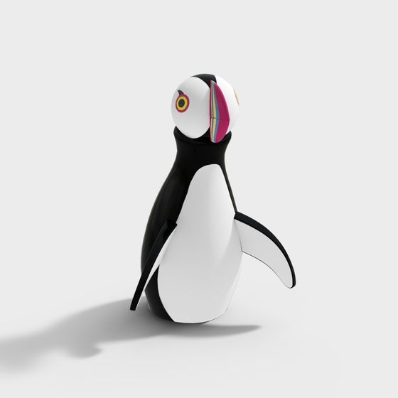 Cute black and white penguin toy with colorful beak on light grey background