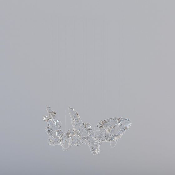 Modern clear glass ceiling light with abstract organic shape hanging on grey background