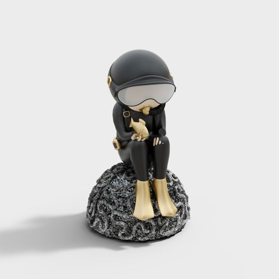 Small black diver figurine with gold boots holding fish on grey background