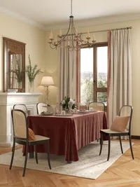 Traditional dining area with red tablecloth black woven chairs rug wood floor and ceiling light