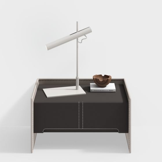 Modern dark brown bedside table with white stitching and white lamp on light grey background