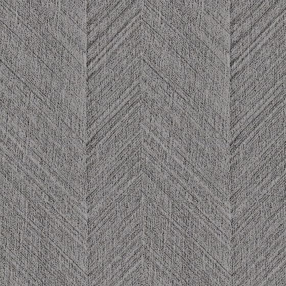 Grey textured wall panel with geometric chevron pattern on grey background