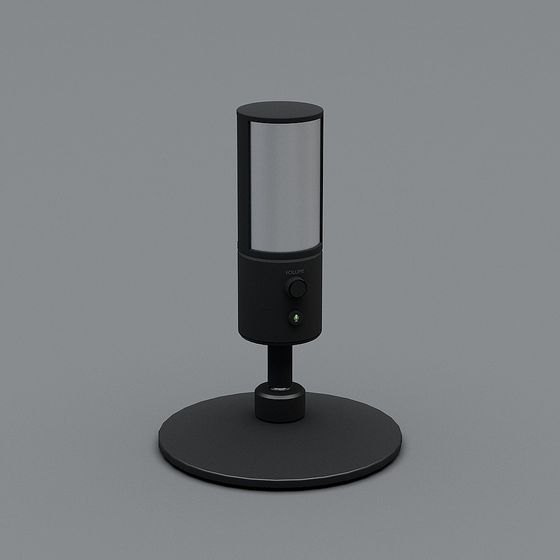 Black table lamp with silver mesh shade and round base on grey background