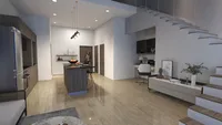 Open plan living area with kitchen island, home office desk, white stairs, and wood floor