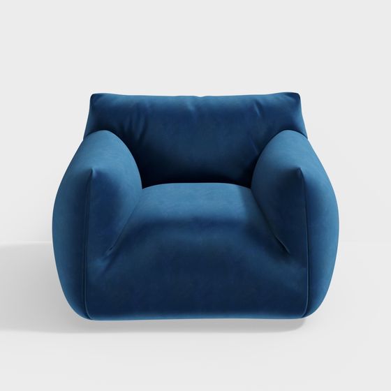 Modern blue velvet armchair with rounded arms and back on white background