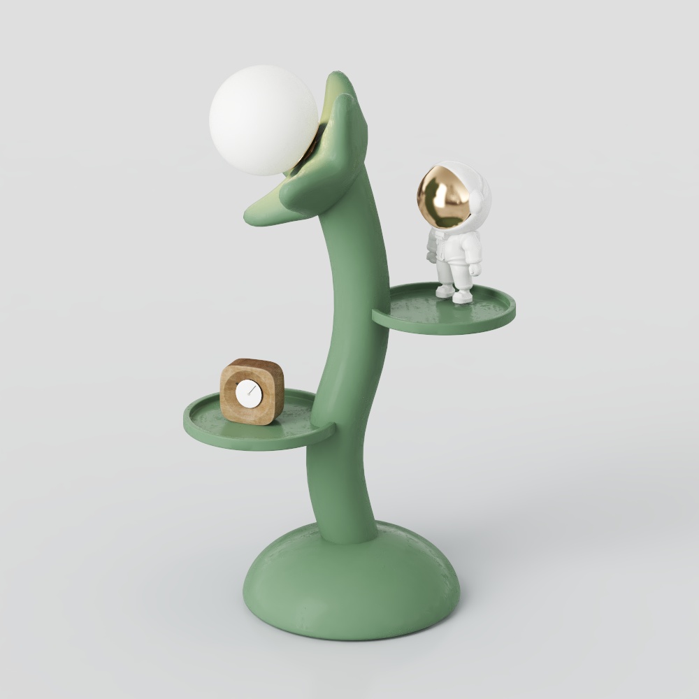 Green metal desk lamp with round bulb and small astronaut figure on grey background