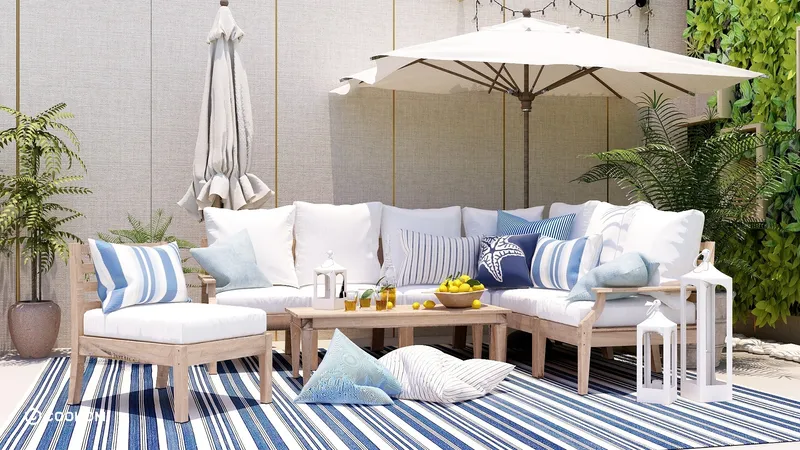 Outdoor patio with wooden sofa blue and white pillows large umbrella striped rug and lanterns