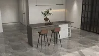 Modern grey dining island with two brown stools plant in vase and white wall panel