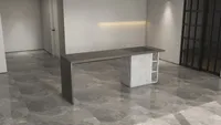 Minimalist grey kitchen island with white ribbed base and marble floor in an empty room