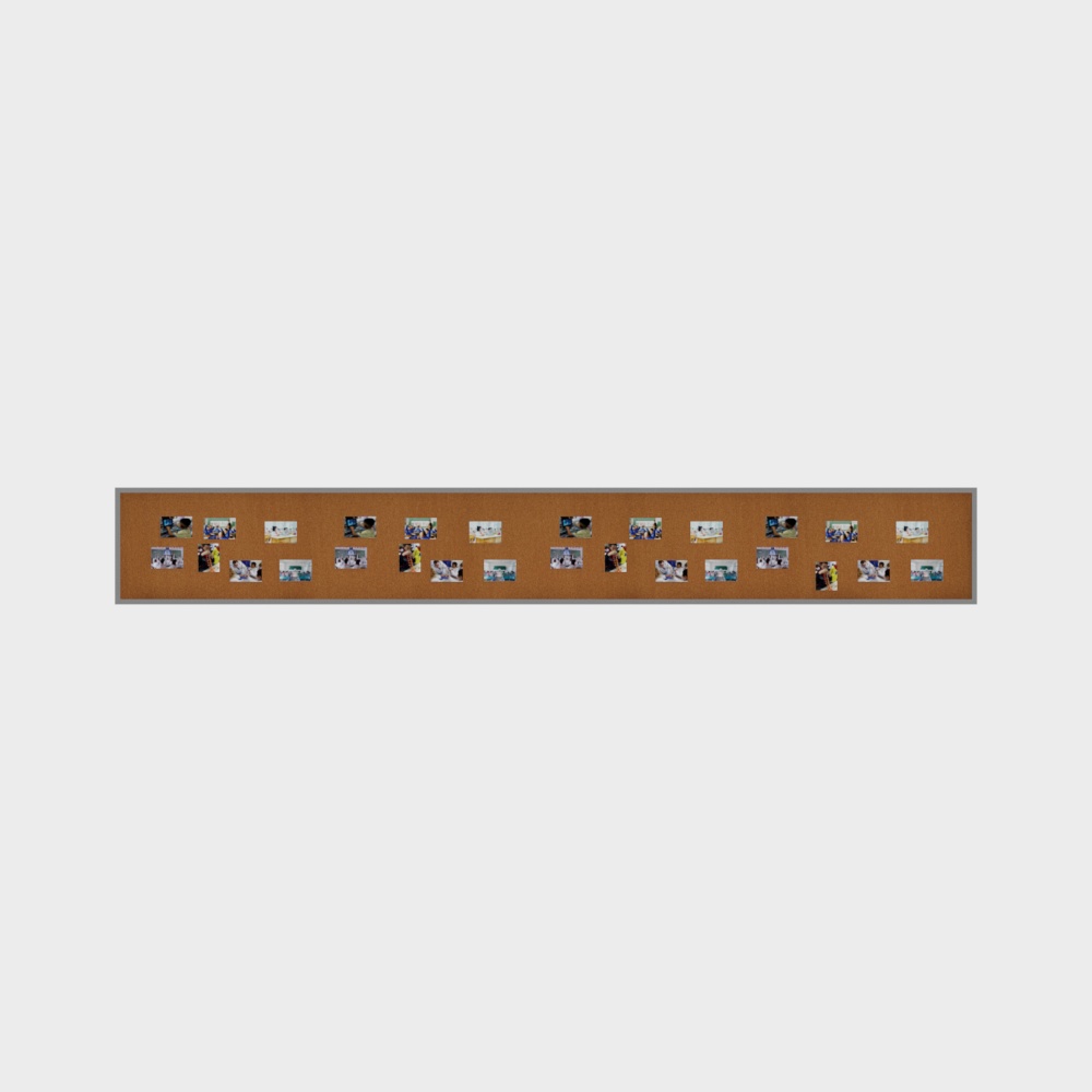 Long brown cork board with silver frame and small photos on white background
