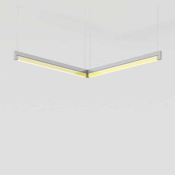 Modern v shaped ceiling light with silver frame and warm yellow glow on grey background