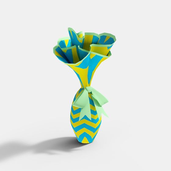 Blue and yellow zigzag paper vase with green ribbon bow on white background