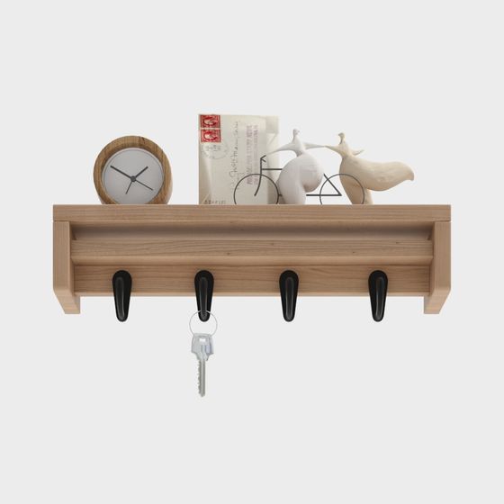 Light wood wall shelf with four black hooks holding keys and decor on white background